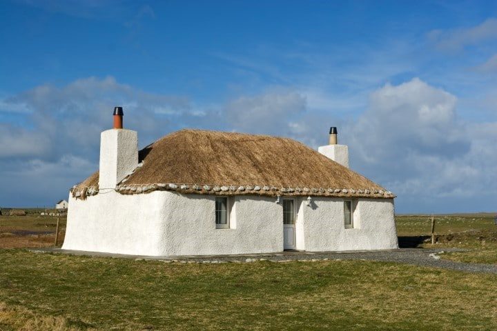 A traditional thatched whitewashed cottage in South Uist, The Outer Hebrides, Scotland.